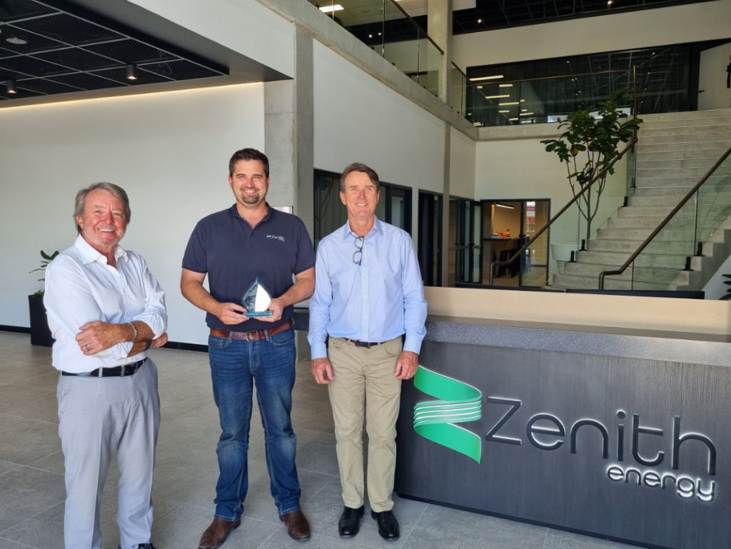 Doug Walker and Hamish Moffat presenting Simon Jelly with a Zenith Energy 10 years of service trophy in the reception of the Zenith HQ building.